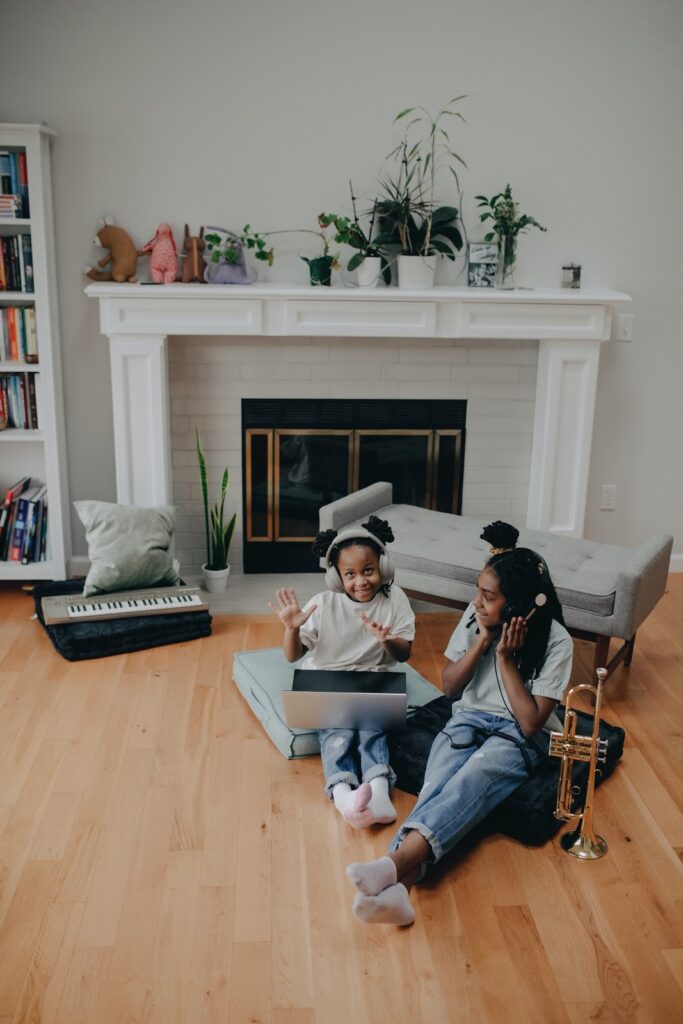 two young females sitting with headphones on having a music bond