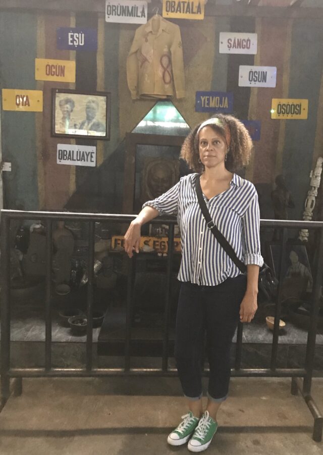 the mini shrne at Fela's shrine that displays names of deities and a shirt of Fela hanging in the center