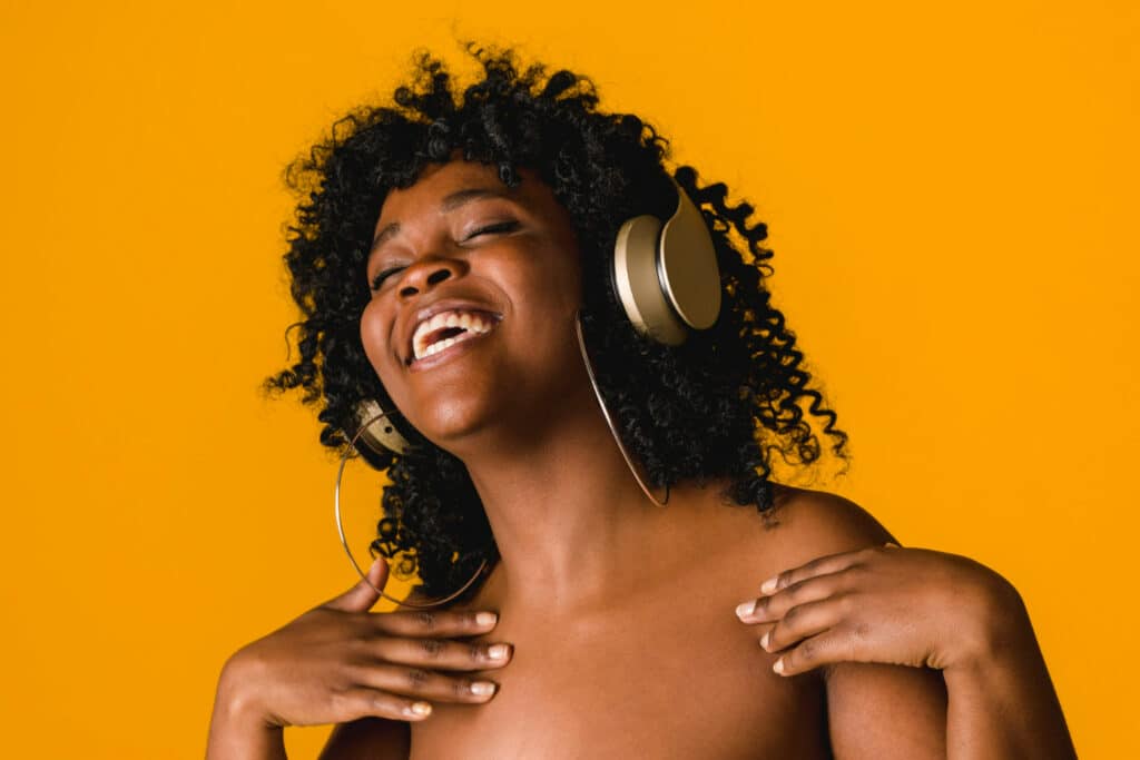 African woman enjoying music with headphones